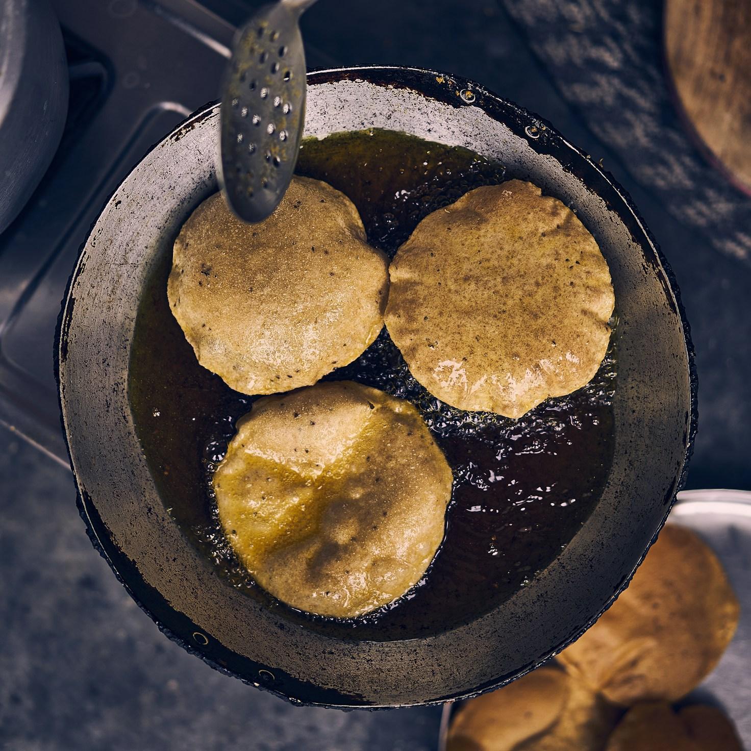 Community members collaborating in a modern kitchen space, sharing recipes and cooking techniques